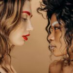 Close-up side profile of fashionable women with creative makeup and artistic style.